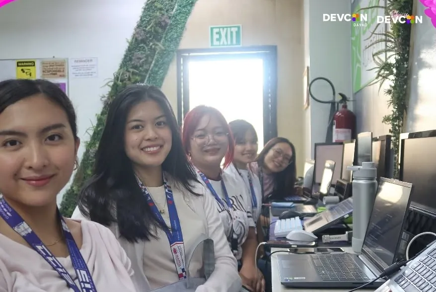Women participants smiling at their workstations
