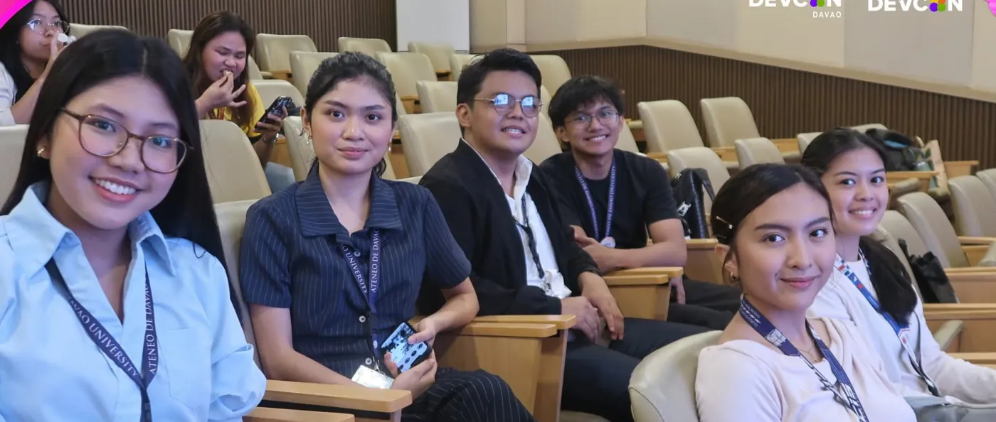 Smiling students seated in an auditorium at the Davao event