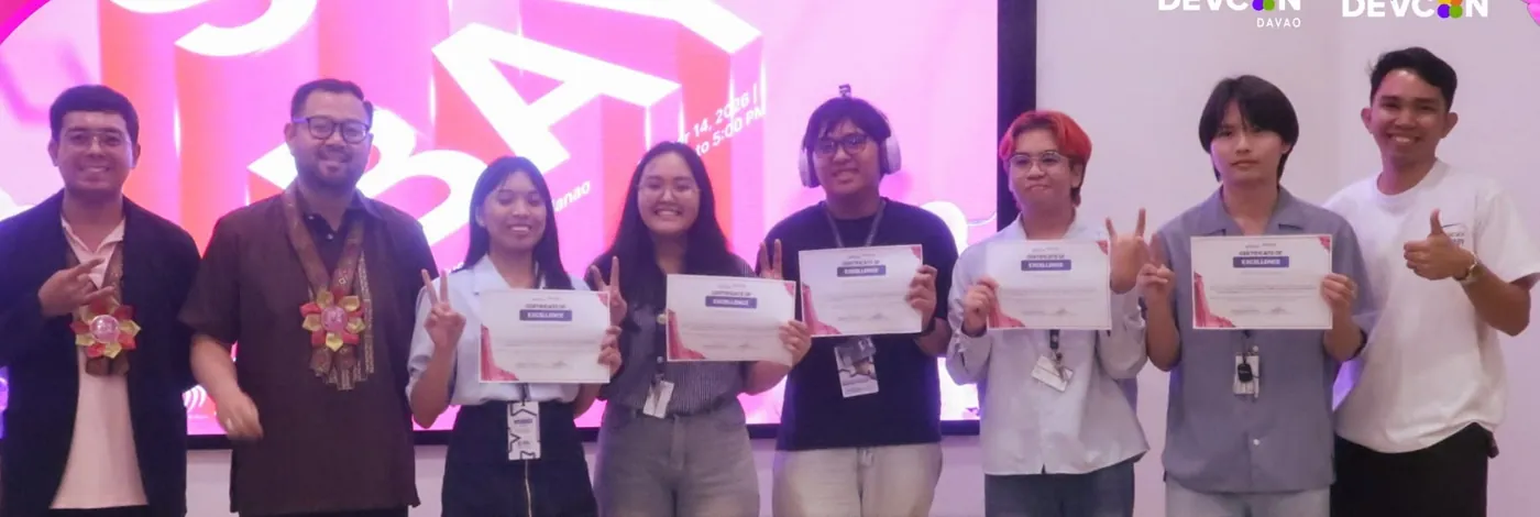 The champion team and mentors holding certificates of excellence