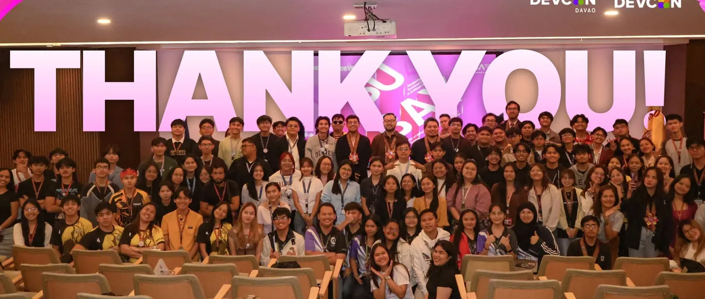 More than a hundred students, mentors, and partners pose together under a giant THANK YOU at the #SHEISDEVCON Davao event
